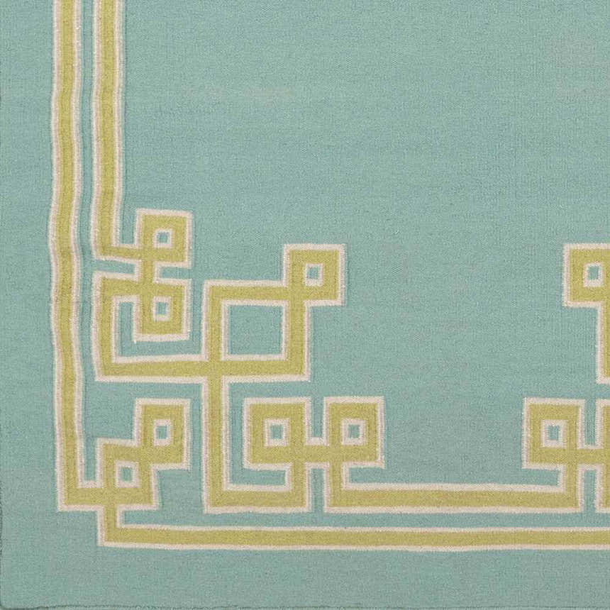 Close-up of the Manitou Area Rug showing its aqua wool texture and light olive geometric border pattern. Swatch