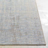 Close-up of the Manzanita Area Rug. Blue, cream, and taupe hues create a contemporary pattern. Machine woven texture. Front