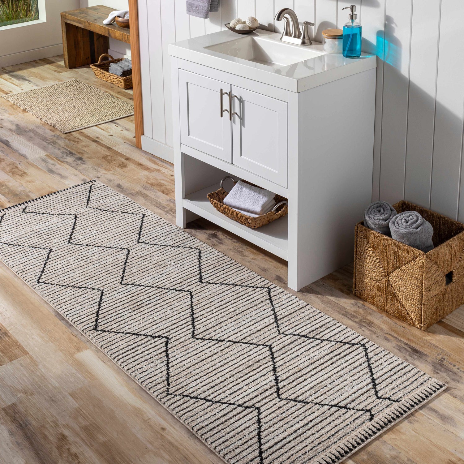 Bathroom scene with a Maonon Area Rug runner in dark gray and lambswool, featuring a geometric pattern on wood floor. Roomscene-Runner