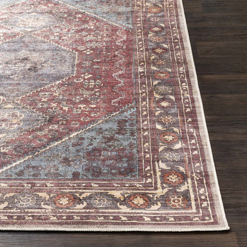 Close-up of the traditional Maplesville Washable Area Rug. Colors include beige, dark pink, plum, green, rust, and teal. Front