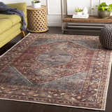 Living room scene with a traditional Maplesville Washable Area Rug. The rug has beige, pink, plum, and teal colors. Roomscene-Rectangle