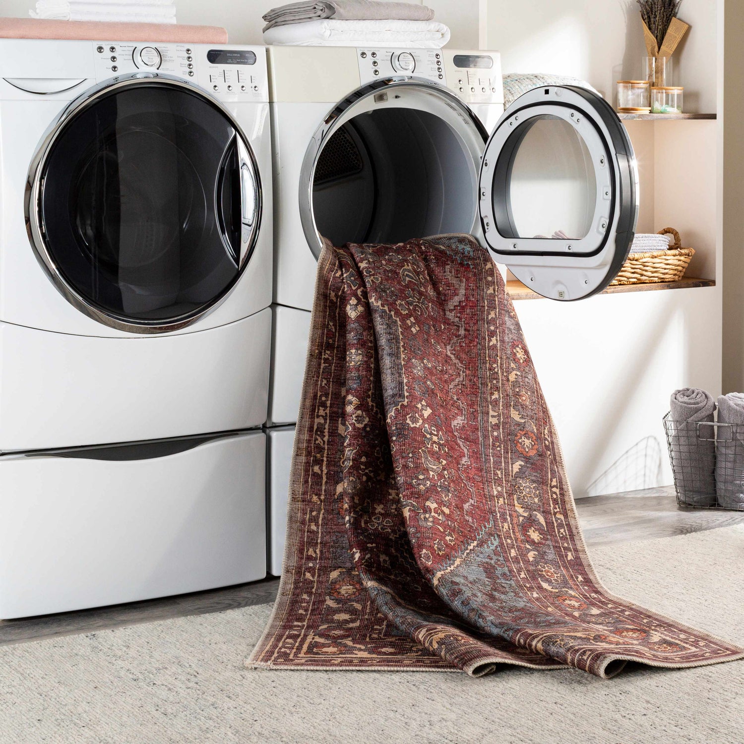 Maplesville Washable Area Rug in a laundry room, coming out of the dryer. Traditional rug with beige, pink, rust and teal colors. Washing-Machine