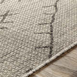 Close-up of the Marwood Nordic Performance Rug showing its charcoal and white geometric pattern and textured weave. Texture