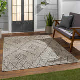 Outdoor patio scene with a taupe Marwood Nordic Performance Rug, gray loveseat, and wood flooring. Roomscene-Rectangle