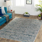 Living room scene with a teal sofa and the Maungatapere Area Rug in cream, gray, and teal. Contemporary style. Roomscene-Rectangle