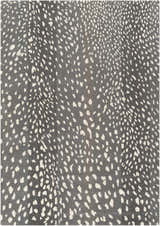 Close-up of the Athena Gray Giraffe Print Wool Rug. Cream spots on a gray, hand-tufted wool rug. Animal print rug. Design-Rectangle-58