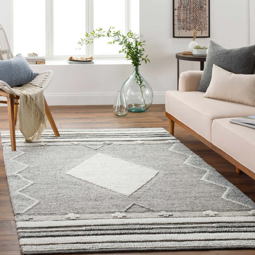 Living room scene with gray and cream Mcdonald Indoor Outdoor Rug, neutral sofa, and natural light. Bohemian style. Roomscene-Rectangle
