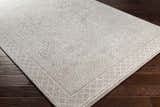 Close-up of the Middleville Luxe Rug. Contemporary style with geometric patterns in charcoal, cream, and light gray. Corner