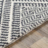 Close-up of the textured Madison Black&White Area Rug with a geometric pattern in black, gray, and white. Texture