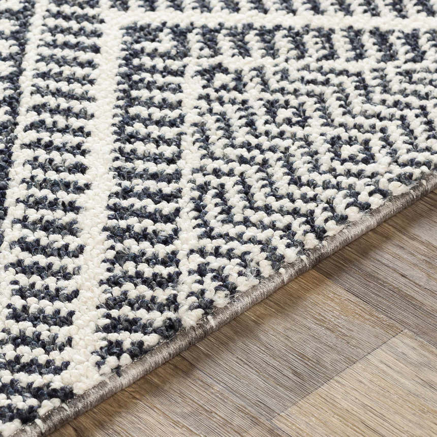 Close-up of the textured Madison Black&White Area Rug with a geometric pattern in black, gray, and white. Texture
