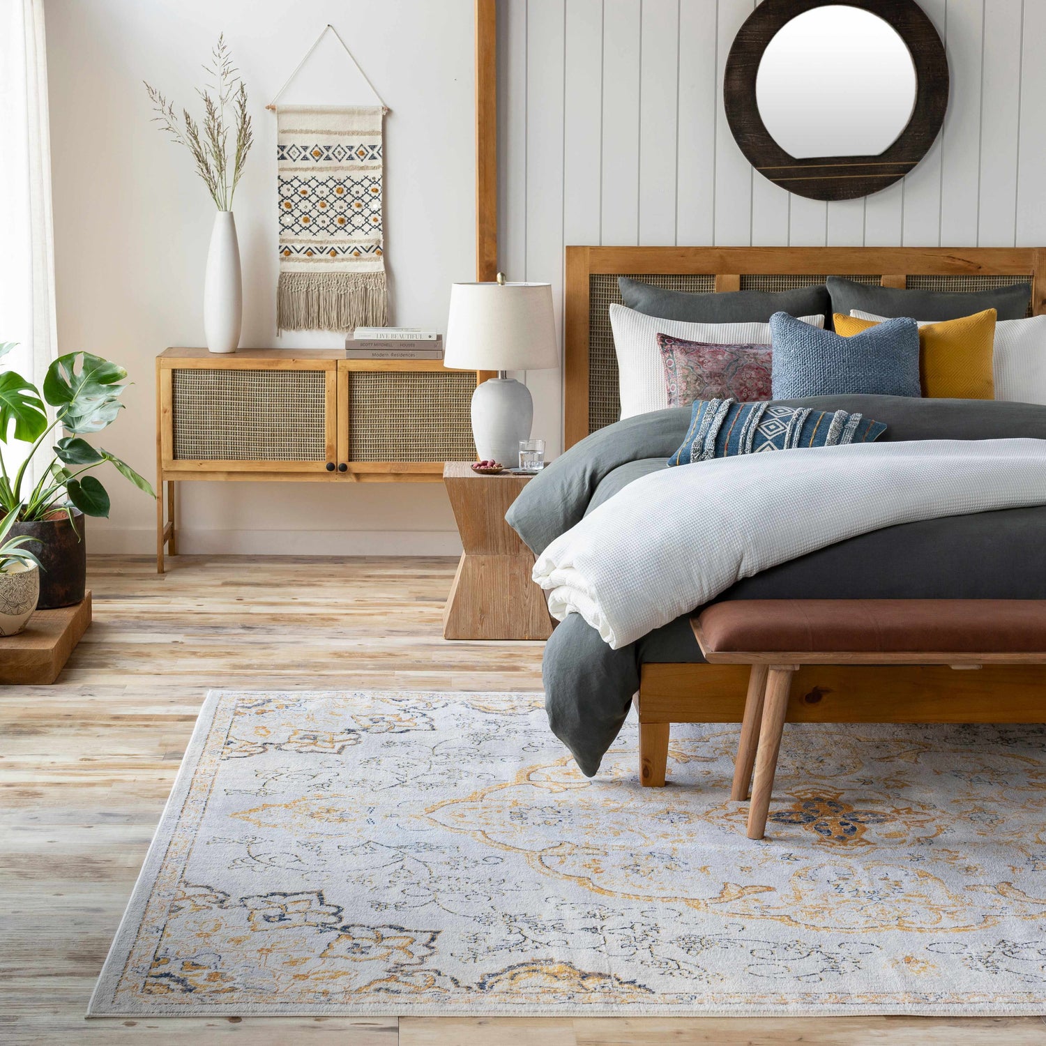Bohemian bedroom scene with the Mehoopany Area Rug in burnt orange and gray, styled with a wooden bed and neutral decor. Roomscene-Rectangle