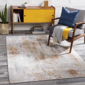 Living room scene with a Melton Textured Luxe Area Rug, mustard cabinet, and gray chair. Roomscene-Rectangle