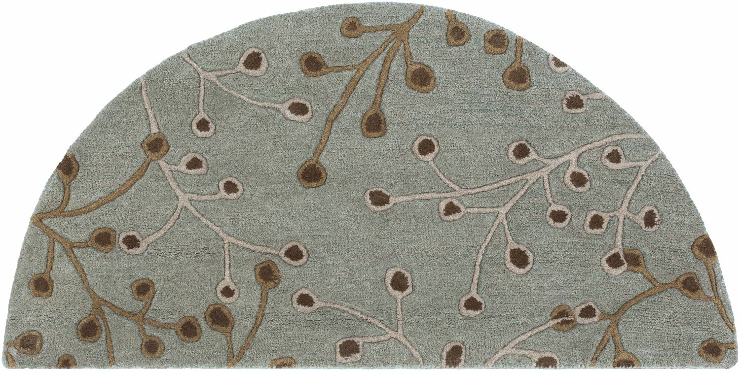 Close-up of the hearth-shaped Sage Elsu Area Rug. Sage background with brown and taupe floral branch pattern. Design-Hearth