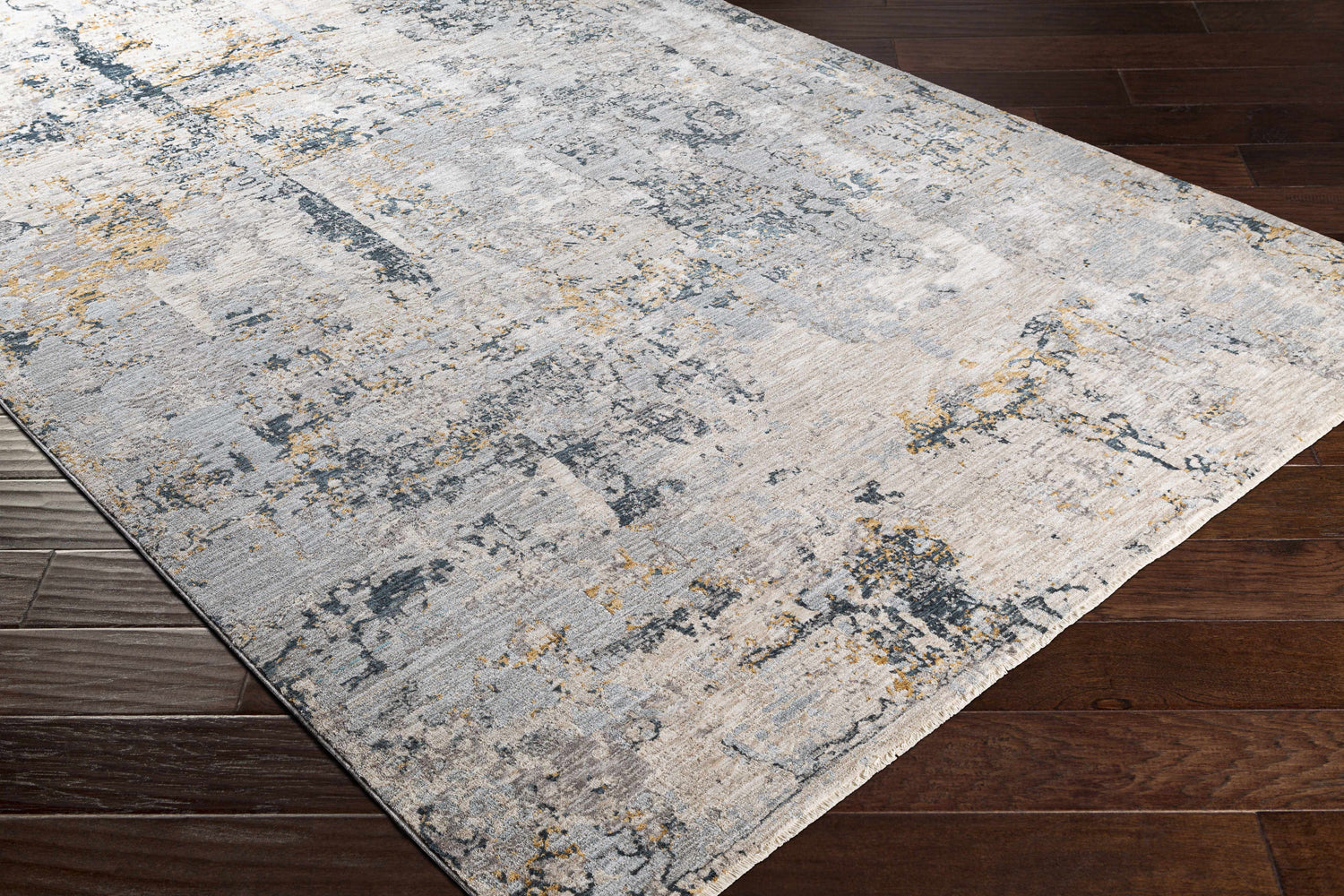 Close-up of the Midfield Luxe Rug showing its charcoal, cream, and gray contemporary design and soft polyester texture. Corner