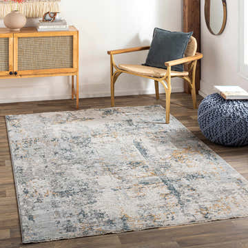 Living room scene with the Midfield Luxe Rug in charcoal, cream, and gray tones, styled with a wood cabinet and chair. Roomscene-Rectangle