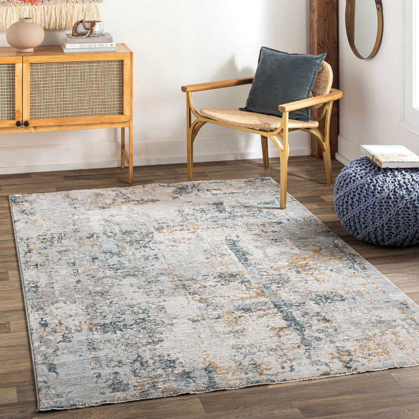 Living room scene with the Midfield Luxe Rug in charcoal, cream, and gray tones, styled with a wood cabinet and chair. Roomscene-Rectangle