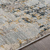 Close-up of the Midfield Luxe Rug showing its charcoal, cream, and gray contemporary pattern and soft, textured polyester material. Texture