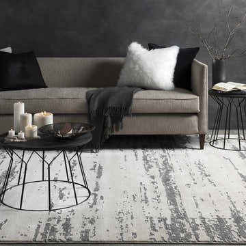 Living room scene with a beige sofa and Mikana Beige Tibetan Rug, creating a modern, neutral aesthetic. Roomscene-Rectangle