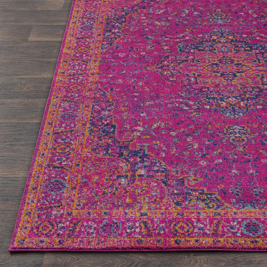 Close up of the Milliken Magenta Area Rug showing its burgundy, orange, gray, and navy traditional pattern. Front