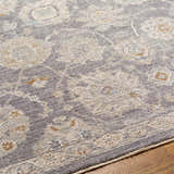 Close up of the Mimarsinan rug showing its traditional oriental pattern and texture in gray, beige and brown tones. Texture
