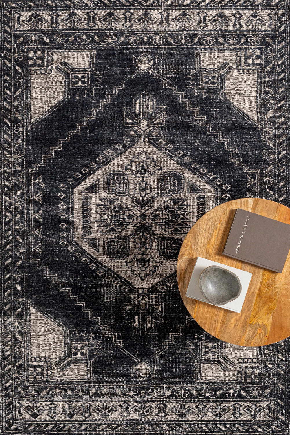 Close-up of the Minapan Premium Area Rug in black and cream, showcasing its traditional, hand-knotted design and geometric patterns. Styleshot