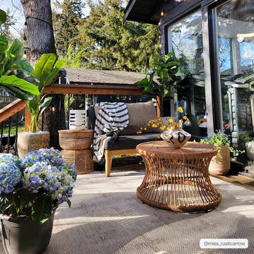 Outdoor patio scene with Limbo Beige area rug, wicker furniture, potted plants, and a cozy, inviting atmosphere. Roomscene-Rectangle