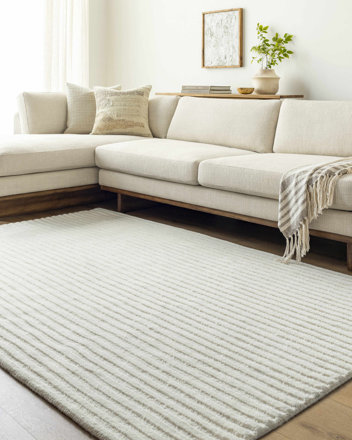 Neutral living room with a cream sectional and the Missa Cream Area Rug. Roomscene-Rectangle