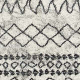 Close up of the Moulden Area Rug. Charcoal, cream, and gray shag rug with a geometric pattern. Swatch