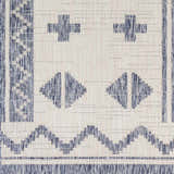 Close-up of the Mangoso Gray Area Rug showing its blue geometric pattern on an off-white woven polypropylene texture. Swatch