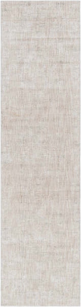 Close-up of the Monto Luxe Rug. Machine-woven polyester rug in charcoal, cream, gray, and tan with a subtle, textured pattern. Design-Runner-2710