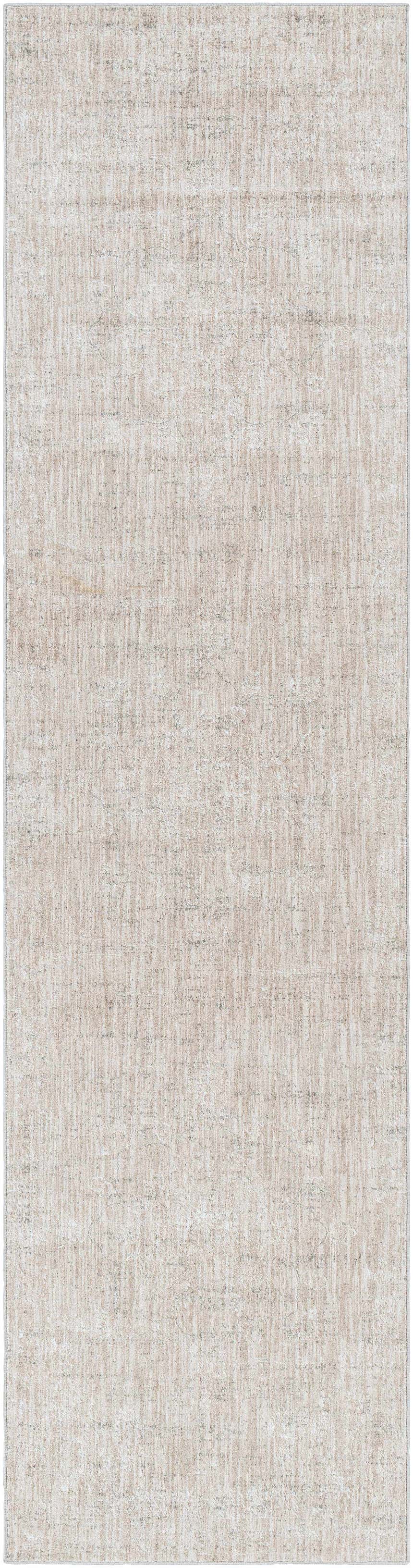 Close-up of the Monto Luxe Rug. Machine-woven polyester rug in charcoal, cream, gray, and tan with a subtle, textured pattern. Design-Runner-2710