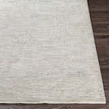 Close-up of the Monto Luxe Rug showing a cream, gray, and taupe traditional pattern and soft, textured weave. Front
