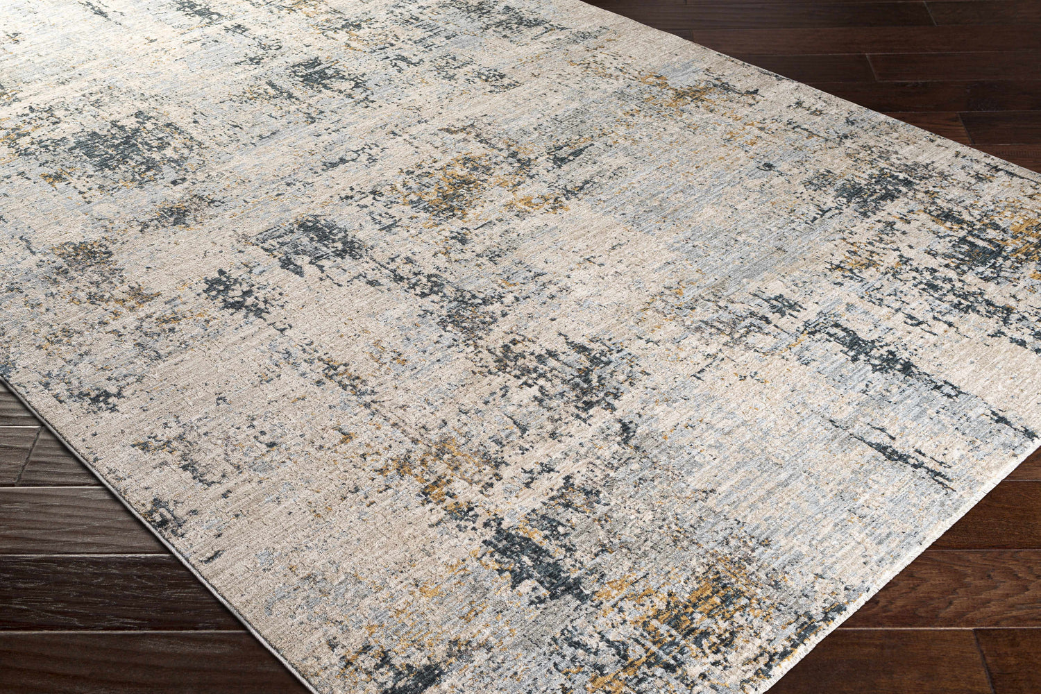 Close-up of the Montreat Luxe Rug, a cream, gray, and mustard abstract pattern on dark wood floors. Corner