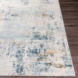 Close-up of the Montreat Luxe Rug showing its cream, gray, teal, and mustard abstract pattern and soft texture. Front