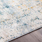 Close-up of the Montreat Luxe Rug showing its cream, teal, and mustard abstract design and soft texture. Texture