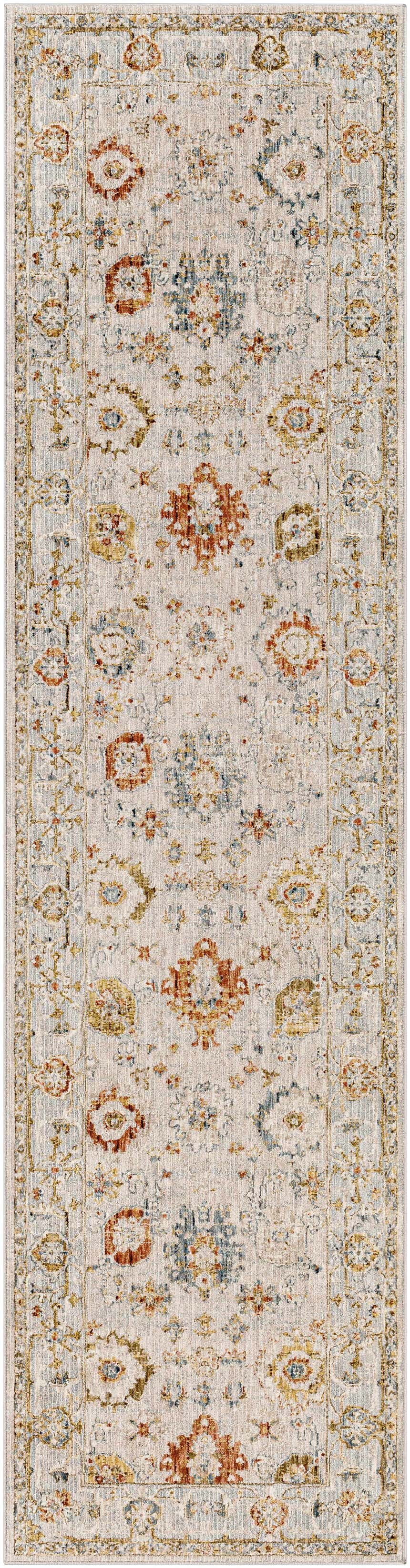 Close-up of a Mogul Luxe Oushak Rug. The rug features a traditional floral pattern in brick red, cream, denim, and tan tones. Design-Runner-2710