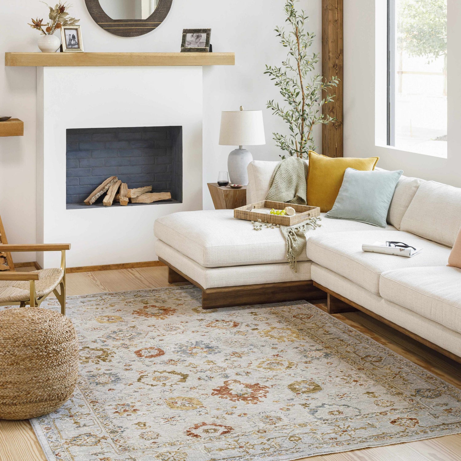 Living room scene with a cream sectional sofa and the Mogul Luxe Oushak Rug in brick red, cream, and denim. Roomscene-Rectangle