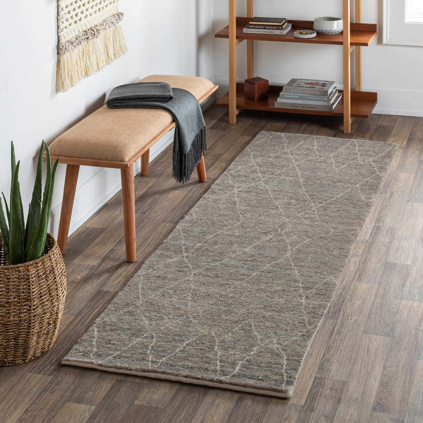 Entryway with Molugan Gray Premium Wool Rug, wood floors, bench, woven wall hanging, and wood shelving unit. Roomscene-Runner
