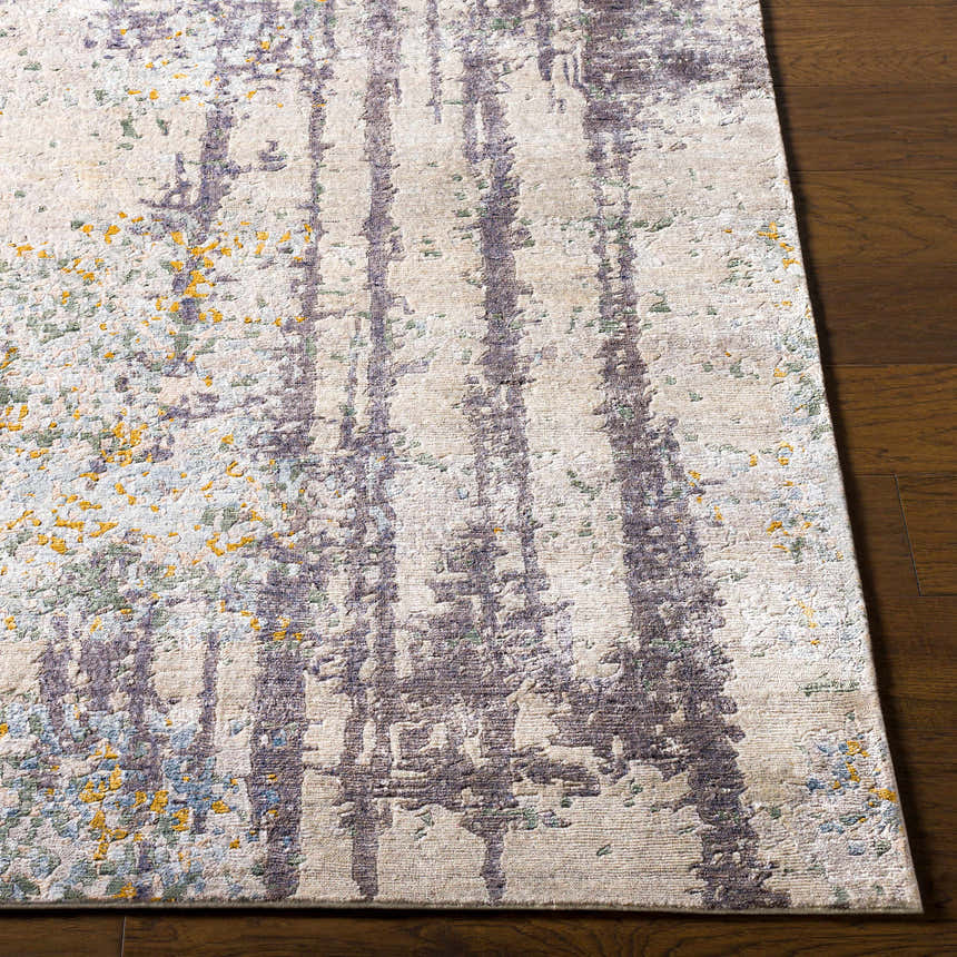 Close up of the Moncure Area Rug with black, beige, gray, sage, and mustard colors on a wood floor. Front