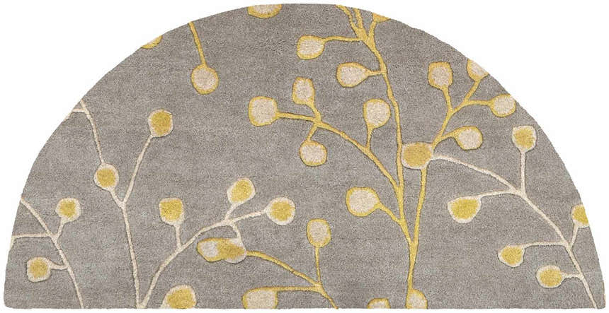 Close-up of Elsu Mustard Wool Area Rug, hearth shape, featuring a floral pattern in mustard and taupe on a charcoal background. Design-Hearth