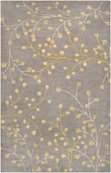 Close-up of the Elsu Mustard Wool Area Rug featuring a floral pattern in mustard and taupe on a charcoal background. Design-Rectangle-58