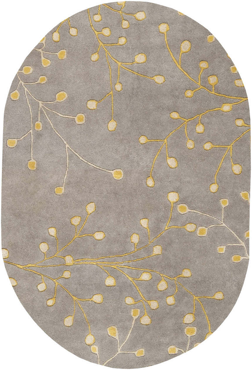 Close-up of an oval Elsu Mustard Wool Area Rug. Features a gray background with a mustard and taupe floral branch pattern. Design-Oval-69