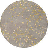 Close-up of the round Elsu Mustard Wool Area Rug featuring a delicate floral pattern in mustard and taupe on a charcoal background. Design-Round-6