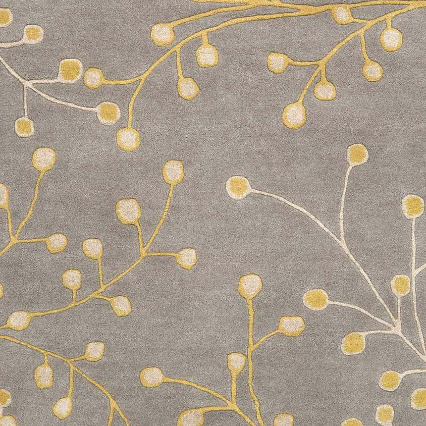 Close-up of Elsu Mustard Wool Area Rug featuring a floral branch pattern in mustard and taupe on a charcoal background. Swatch