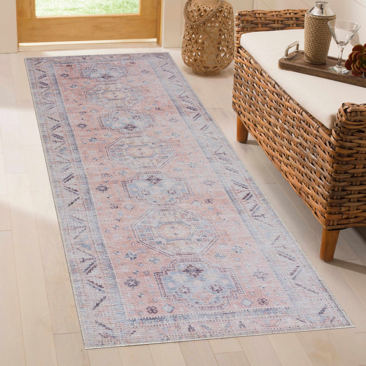 Entryway scene with a Morcott Peach Washable Area Rug runner, wicker bench, wood floors, and natural light. Roomscene-Runner