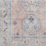 Close-up of the Morcott Peach Washable Area Rug. Features a traditional, oriental-inspired pattern in peach, blue, and ivory tones. Swatch