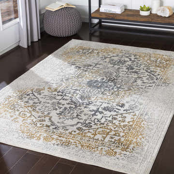 Living room scene with a Morriston Faux Silk rug in charcoal, gray, and mustard. Bohemian style with a vintage, oriental pattern. Roomscene-Rectangle