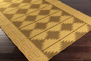 Close-up of the hand woven Morse Area Carpet. Brown and tan Southwestern design, 100% wool rug. Corner