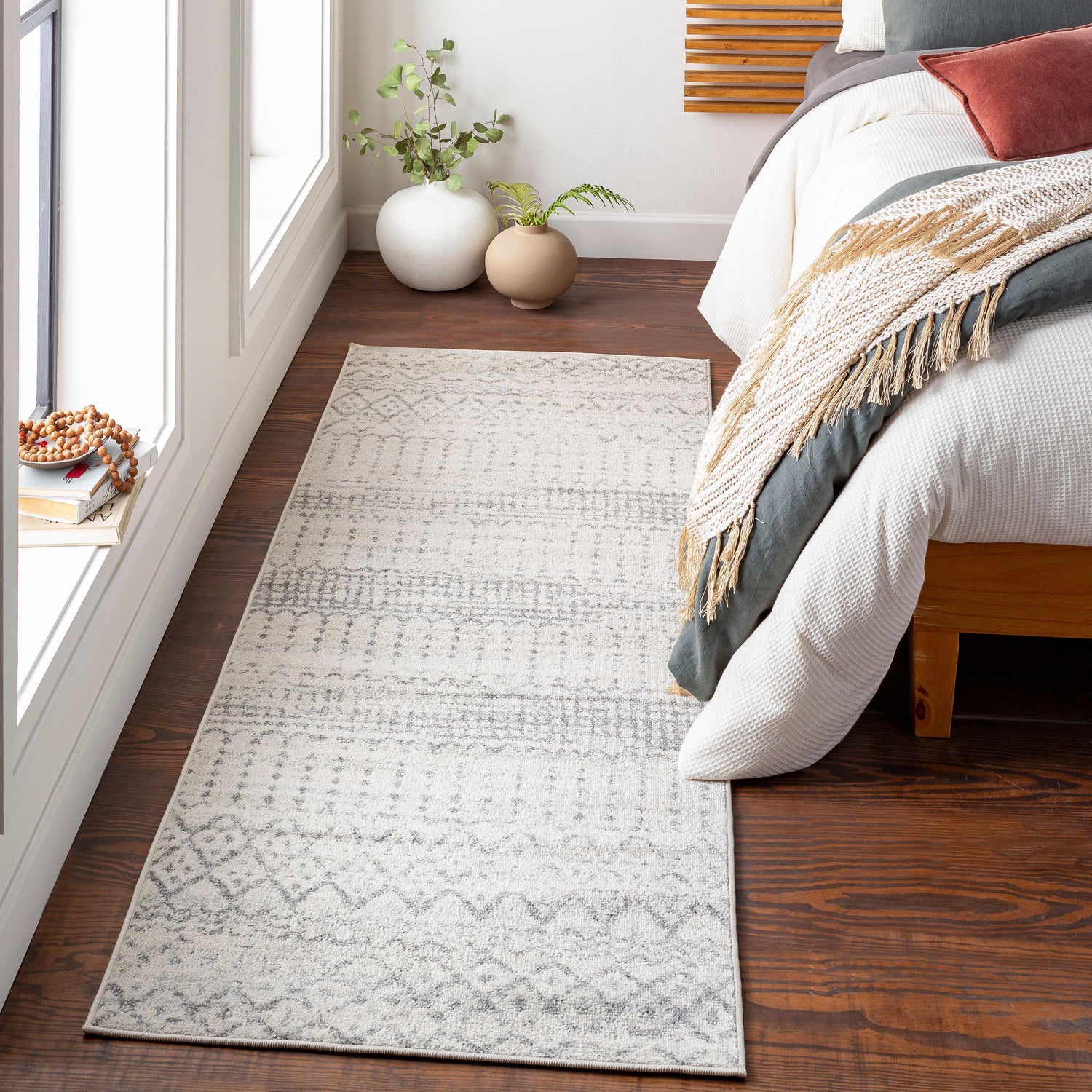 Bedroom scene with Moweaqua Area Rug in charcoal, gray, and ivory. Farmhouse style runner rug on wood floor. Roomscene-Runner