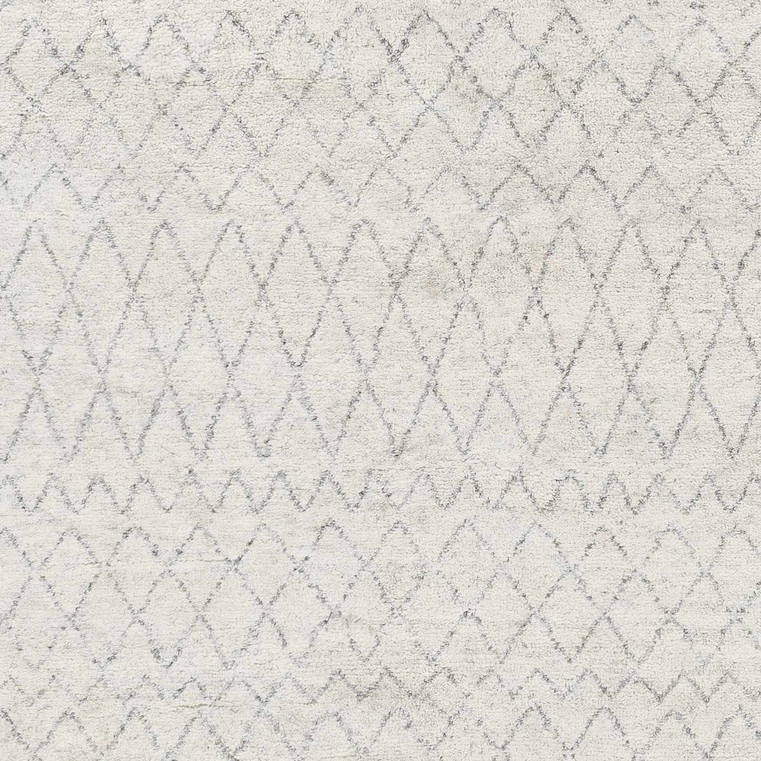 Close-up of the Mozon Handmade Faux Silk Area Rug. Gray, light gray, and medium gray diamond pattern. Hand-knotted texture. Swatch